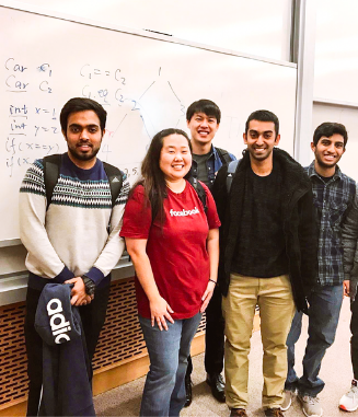 Group of diverse students standing in front of white board