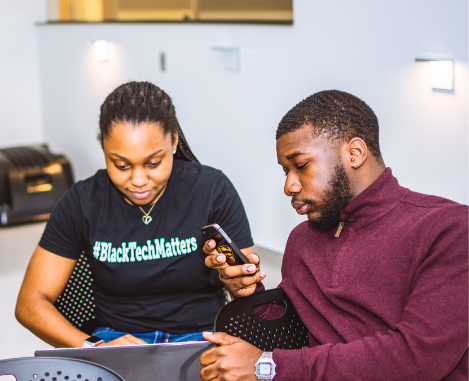 Two black students working together at a laptop