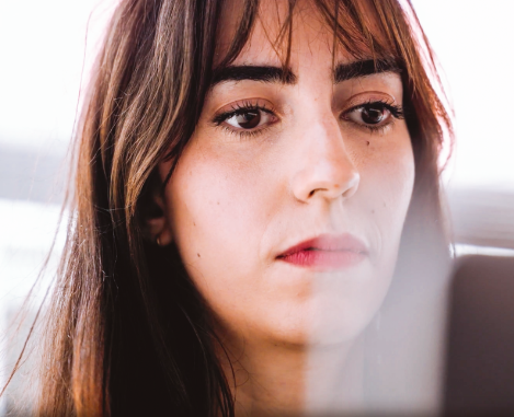 Close up of a female student in front of a laptop