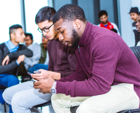 Two men using their phones