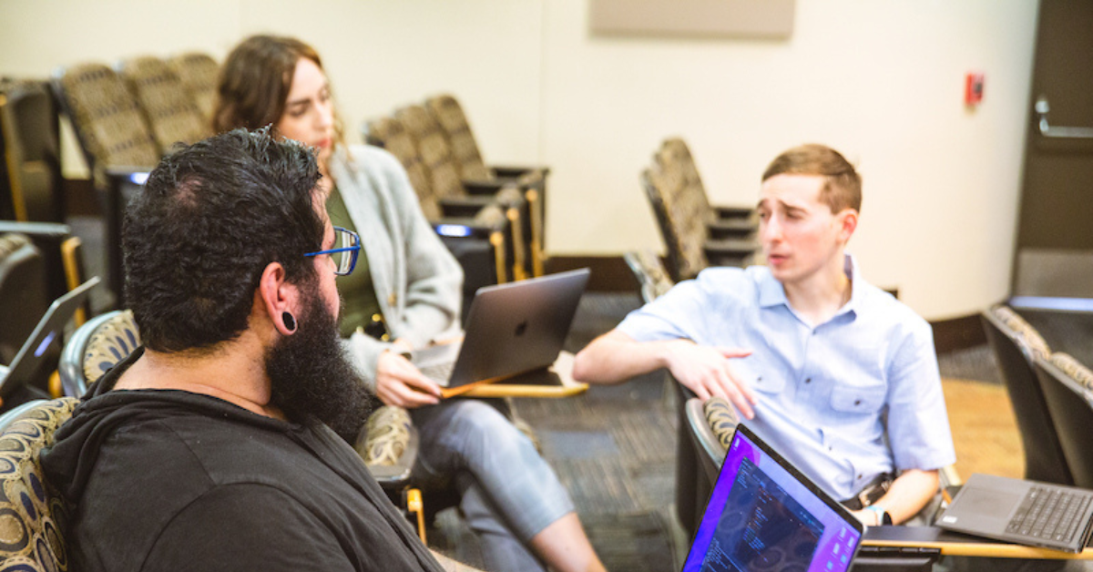 College students talking in an auditorium