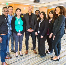 CodePath co-founder, Michael Ellison, standing with a diverse group of students