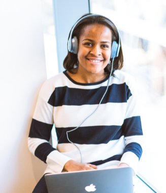 Image of woman wearing headphone with laptop